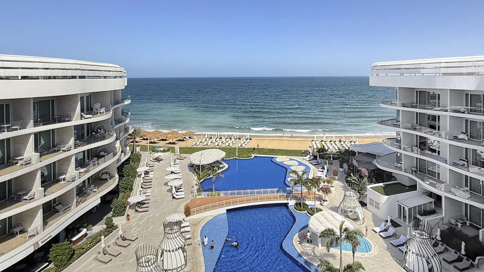 St. Regis Al Mouj Muscat — pools and sea view from the balcony