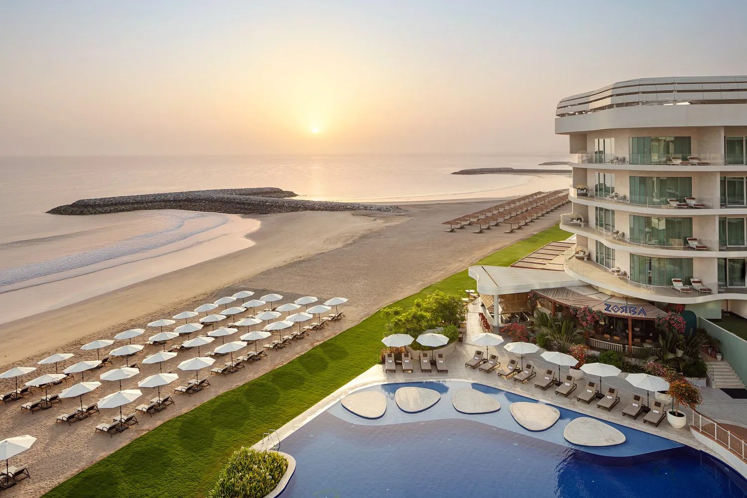 St. Regis Al Mouj Muscat — beach and pool at sunrise